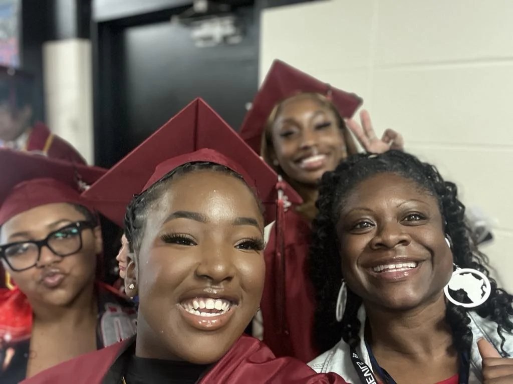 Messenger Creation 11d0c638 57e8 414a B860 7a63a25a4d08 Smiling graduates in maroon caps and gowns taking a selfie with an adult